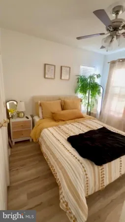 a bedroom with a bed window and a potted plant