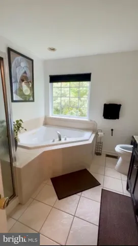 a bathroom with a bathtub and a window