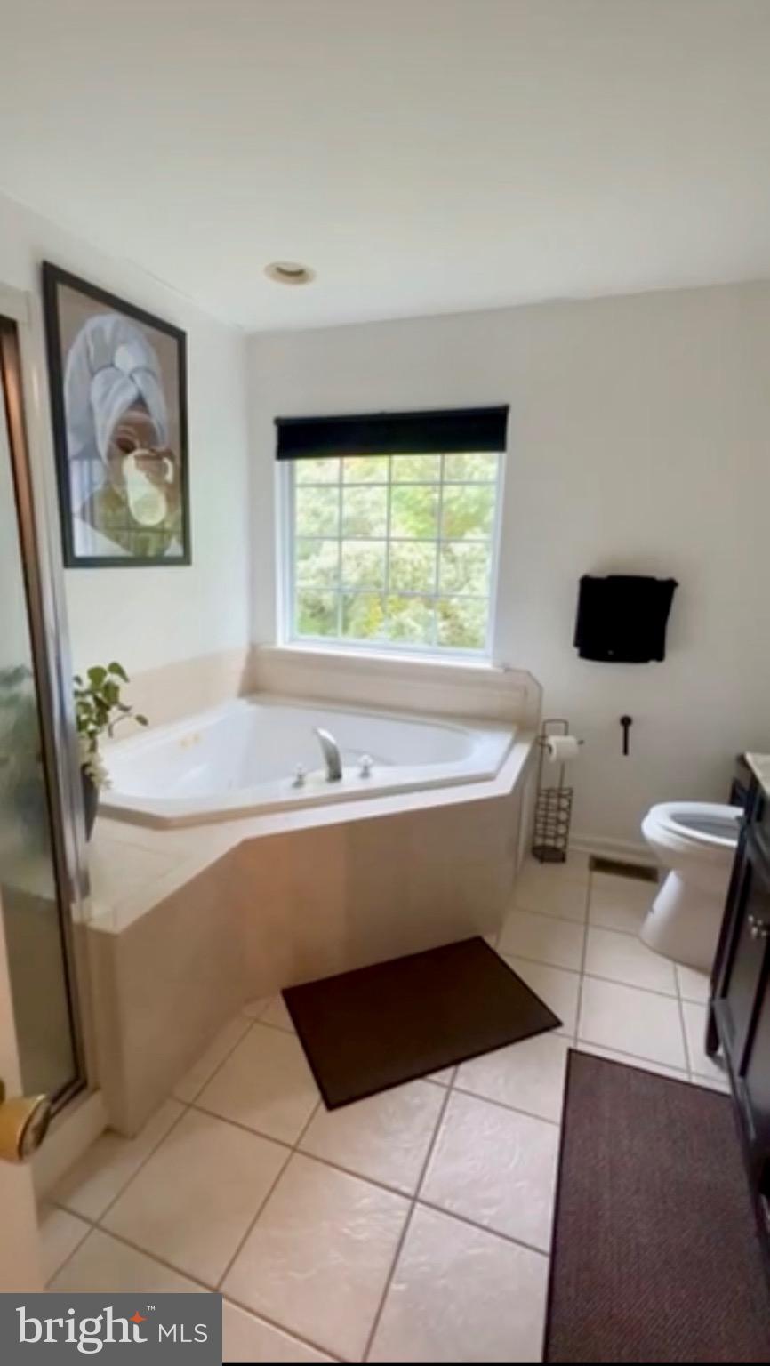 1701 Waltman Road Edgewood, MD 21040 - Photo 10 of 25 a bathroom with a bathtub and a window