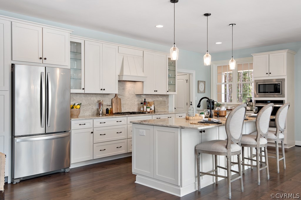 3033 Millmount Lane Powhatan, VA 23139 - Photo 13 of 49 a kitchen with stainless steel appliances granite countertop a refrigerator a sink dishwasher a stove and white cabinets with wooden floor
