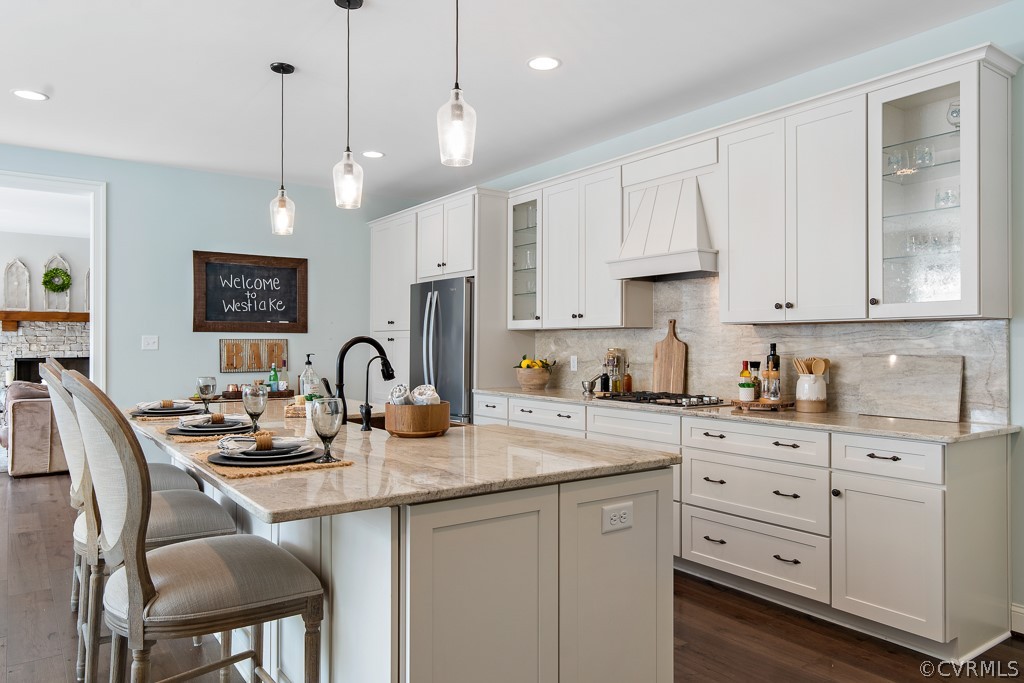 3033 Millmount Lane Powhatan, VA 23139 - Photo 14 of 49 a kitchen with stainless steel appliances granite countertop a sink a stove a dining table and chairs