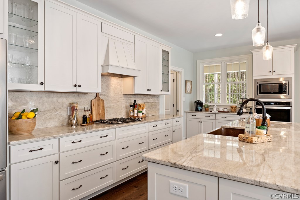 3033 Millmount Lane Powhatan, VA 23139 - Photo 20 of 49 a kitchen with granite countertop a sink a stove and cabinets