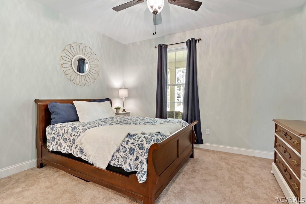 3033 Millmount Lane Powhatan, VA 23139 - Photo 22 of 49 a bedroom with a large bed and a chandelier