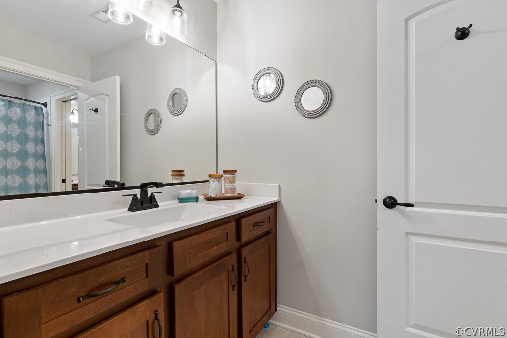 3033 Millmount Lane Powhatan, VA 23139 - Photo 37 of 49 a bathroom with a double vanity sink and a mirror