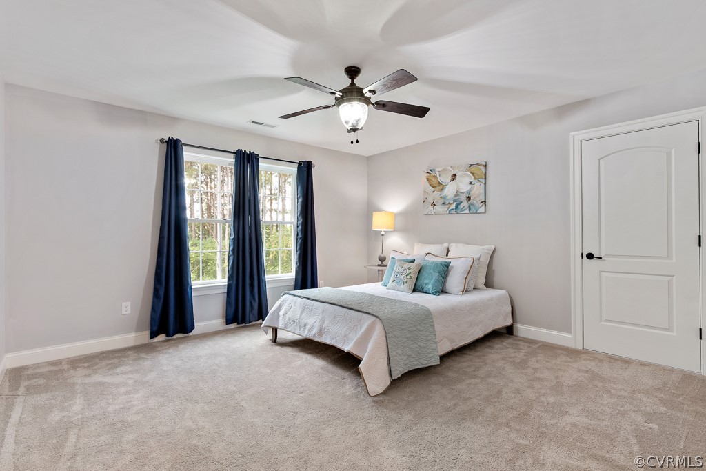 3033 Millmount Lane Powhatan, VA 23139 - Photo 40 of 49 a bedroom with a large bed and a chandelier