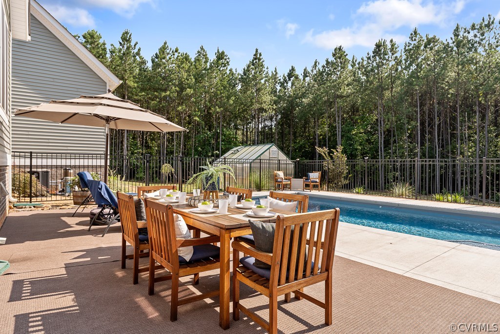 3033 Millmount Lane Powhatan, VA 23139 - Photo 41 of 49 a view of a patio with a table and chairs under an umbrella