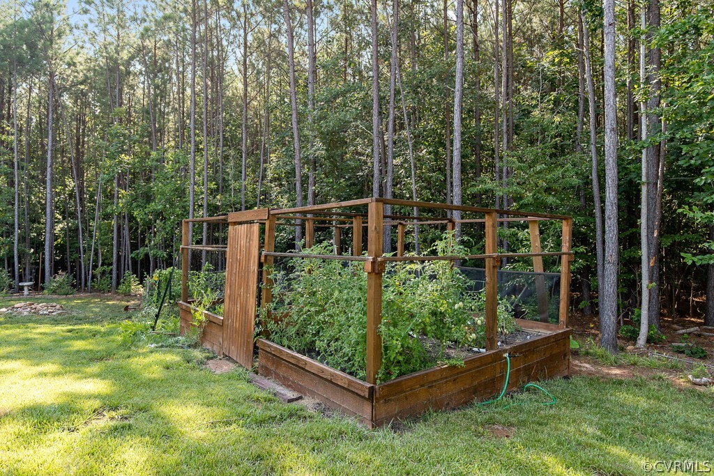 3033 Millmount Lane Powhatan, VA 23139 - Photo 48 of 49 a view of a backyard with wooden fence and a bench