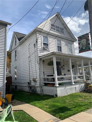 a view of a house with backyard porch and sitting area