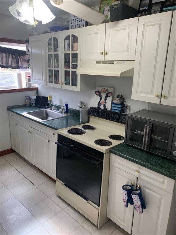 1408 Orr Avenue Kittanning, PA 16201 - Photo 3 of 11 a kitchen with stainless steel appliances granite countertop a sink stove and cabinets
