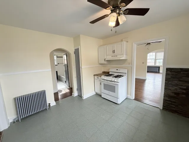 a view of kitchen with sink microwave and cabinets