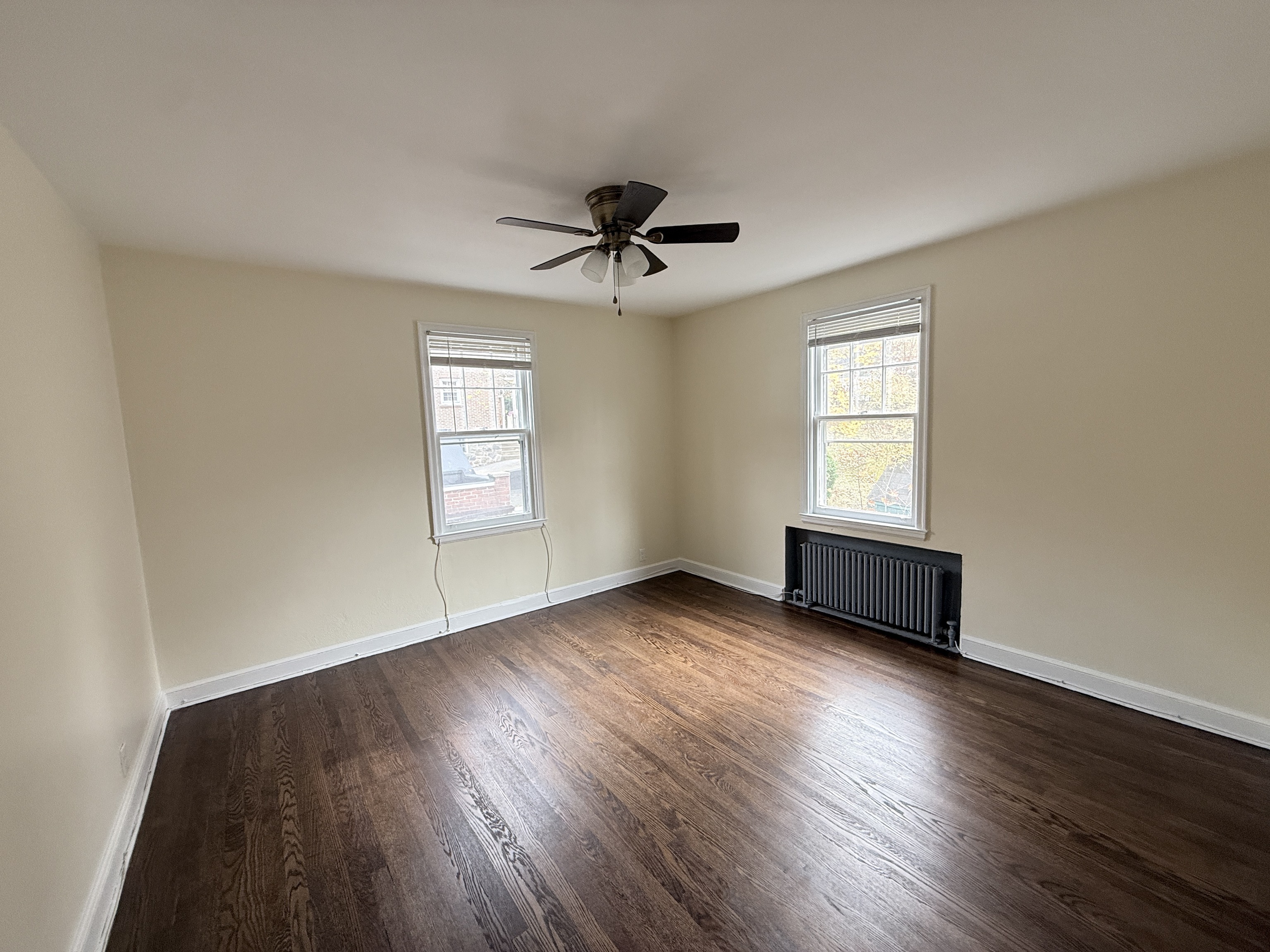89 Hillside Avenue Torrington, CT 06790 - Photo 14 of 17 an empty room with wooden floor ceiling fan and windows