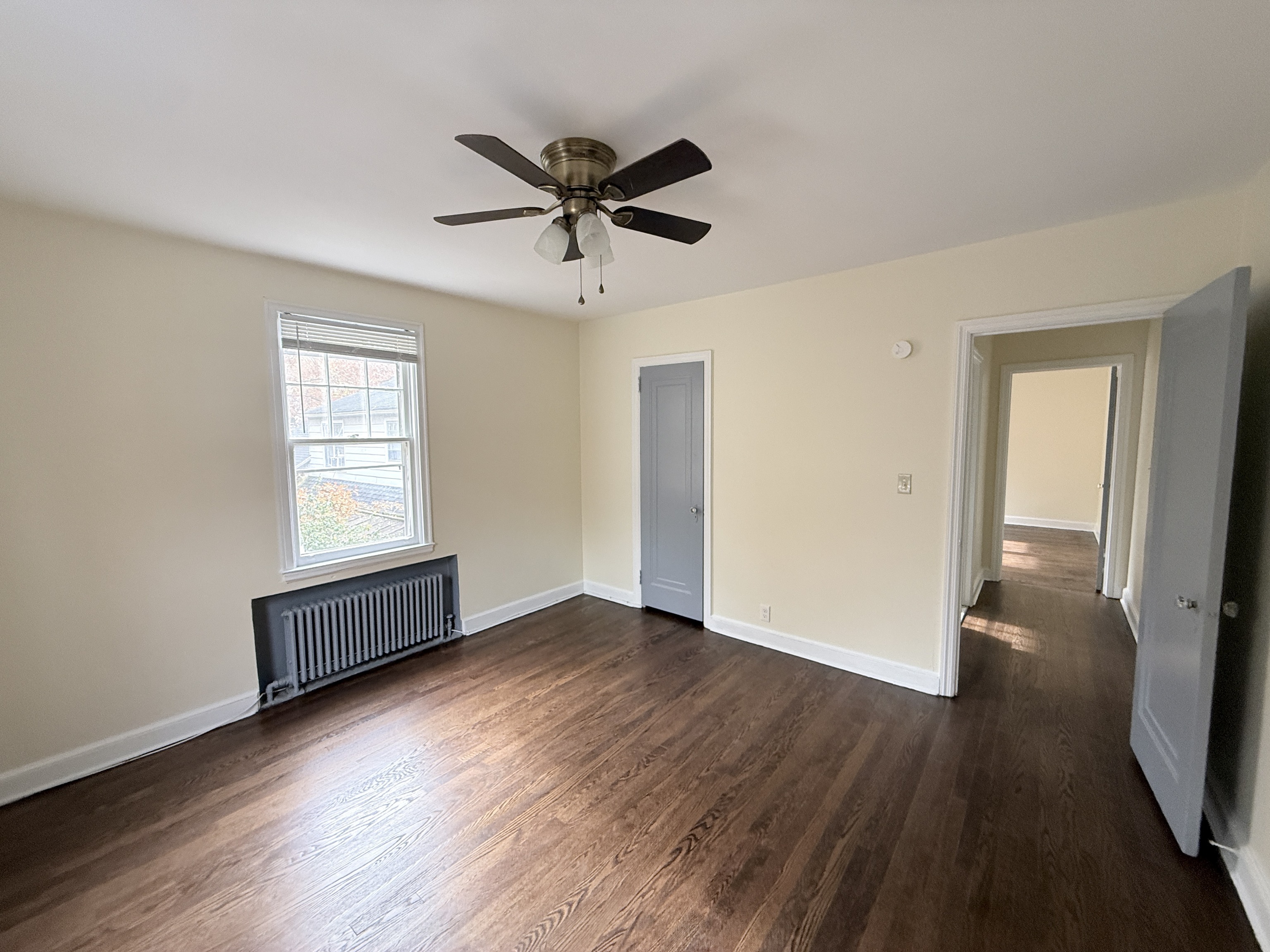 89 Hillside Avenue Torrington, CT 06790 - Photo 15 of 17 an empty room with wooden floor fan and windows