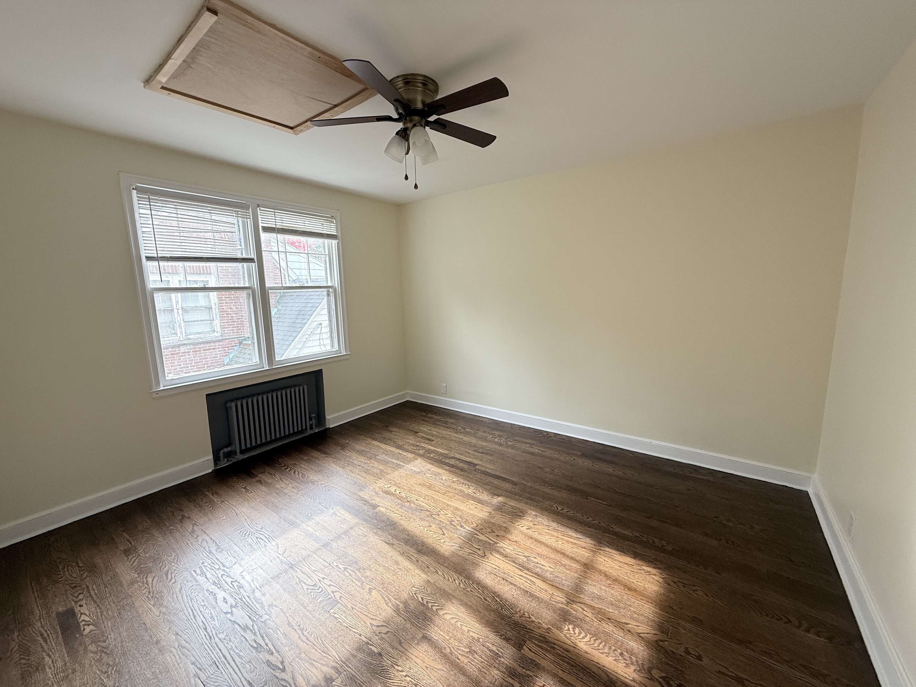 89 Hillside Avenue Torrington, CT 06790 - Photo 16 of 17 an empty room with wooden floor fan and windows