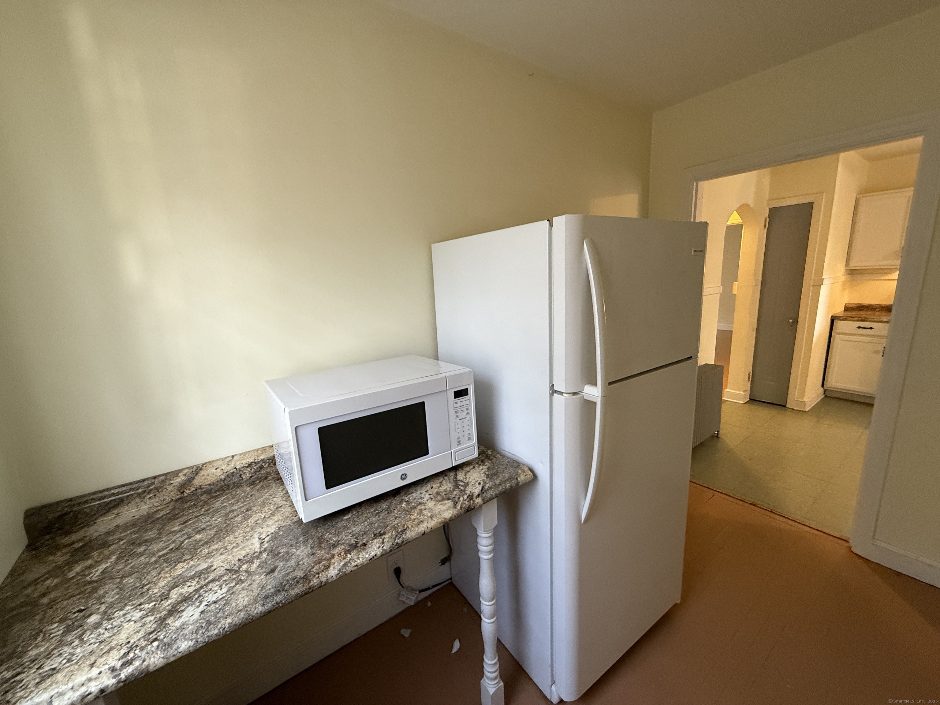 89 Hillside Avenue Torrington, CT 06790 - Photo 4 of 17 a kitchen with granite countertop cabinets and refrigerator