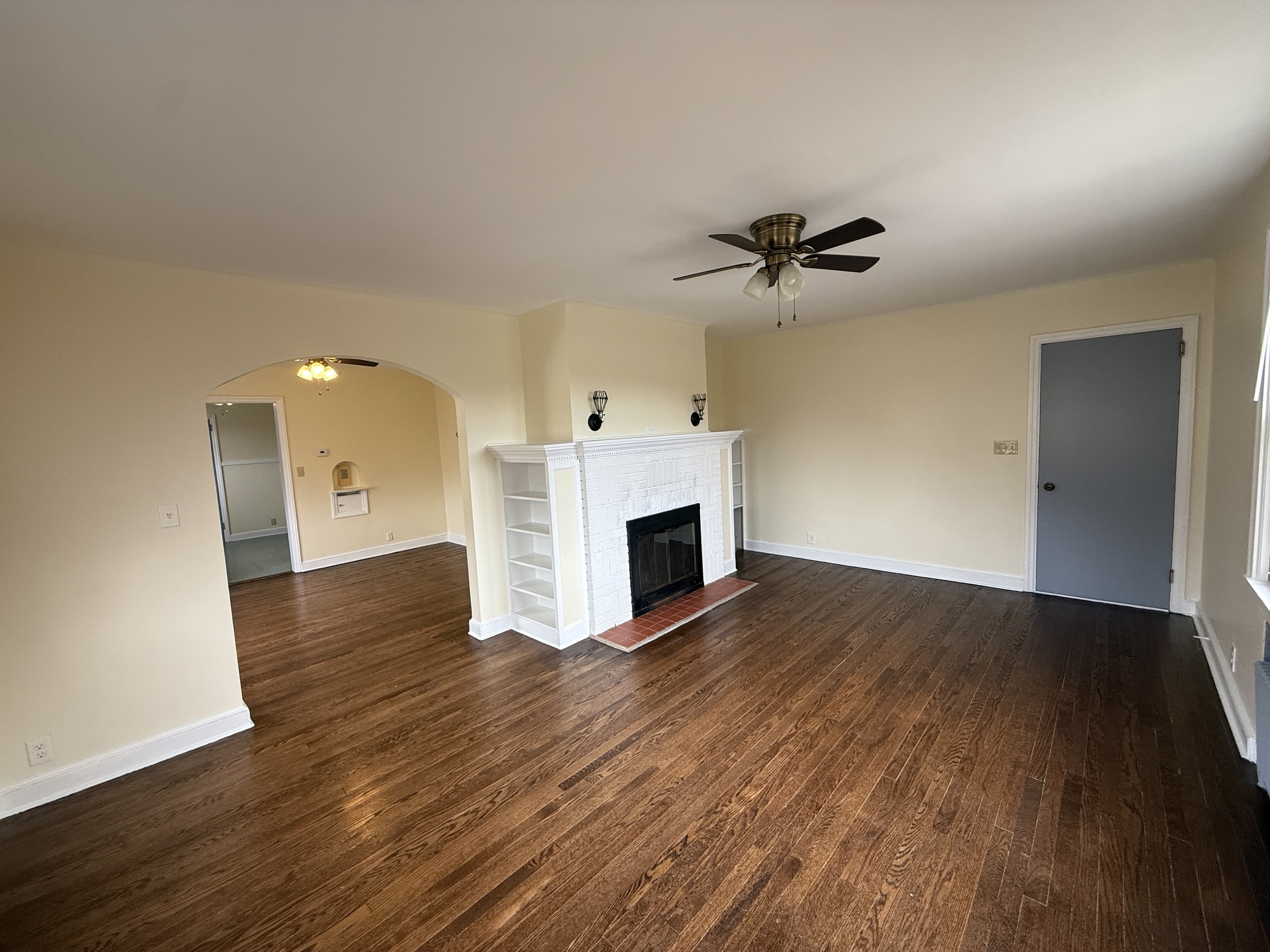 89 Hillside Avenue Torrington, CT 06790 - Photo 6 of 17 a view of a livingroom with a fireplace a ceiling fan and wooden floor