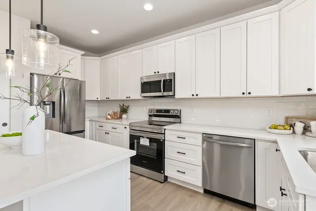 a room with kitchen island a chandelier and a sink
