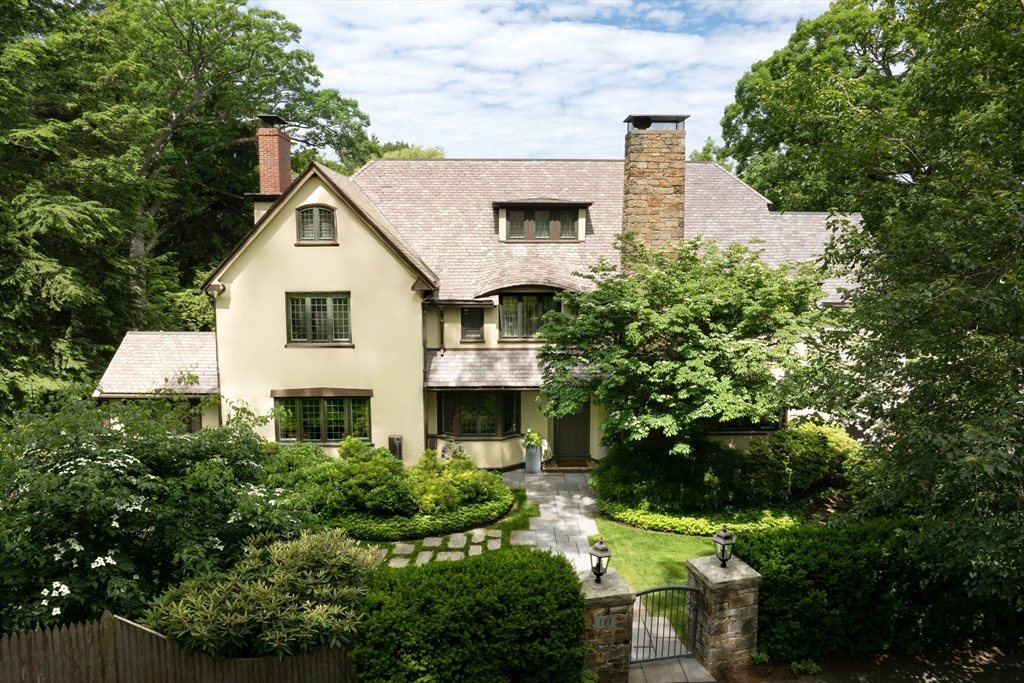 a view of a house with a yard and potted plants