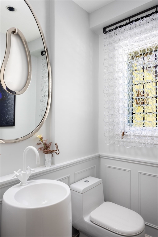 10 Spooner Road Brookline, MA 02467 - Photo 13 of 26 a bathroom with a toilet a sink and a mirror