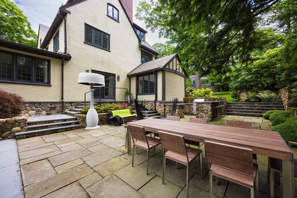 10 Spooner Road Brookline, MA 02467 - Photo 20 of 26 a view of a patio with table and chairs and potted plants