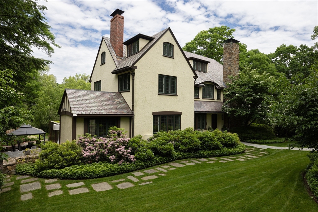 10 Spooner Road Brookline, MA 02467 - Photo 23 of 26 a front view of a house with a garden