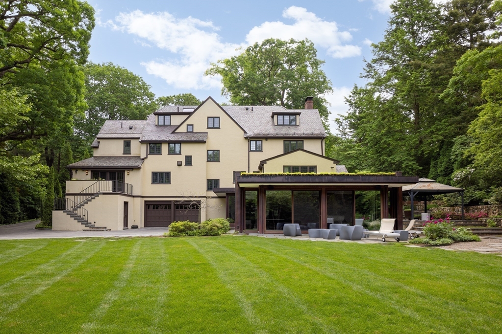 10 Spooner Road Brookline, MA 02467 - Photo 24 of 26 a front view of a house with a garden and porch