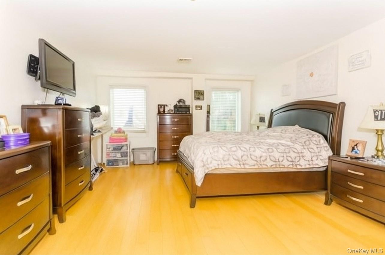 1490 Outlook Avenue, Unit 1A Bronx, NY 10465 - Photo 7 of 12 Bedroom with light wood-type flooring