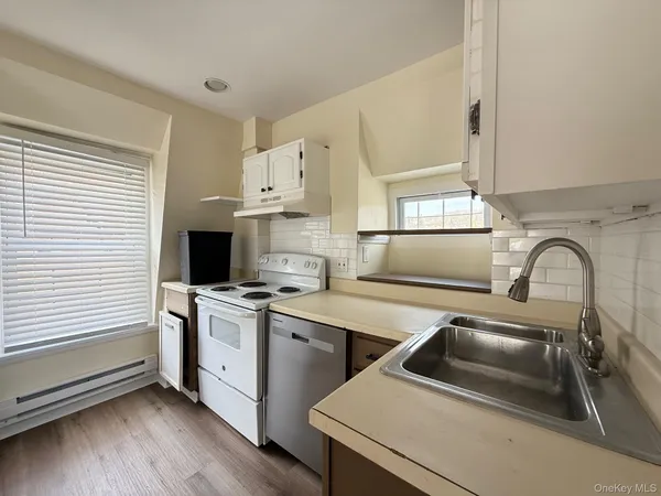 a kitchen that has a sink and a stove in it