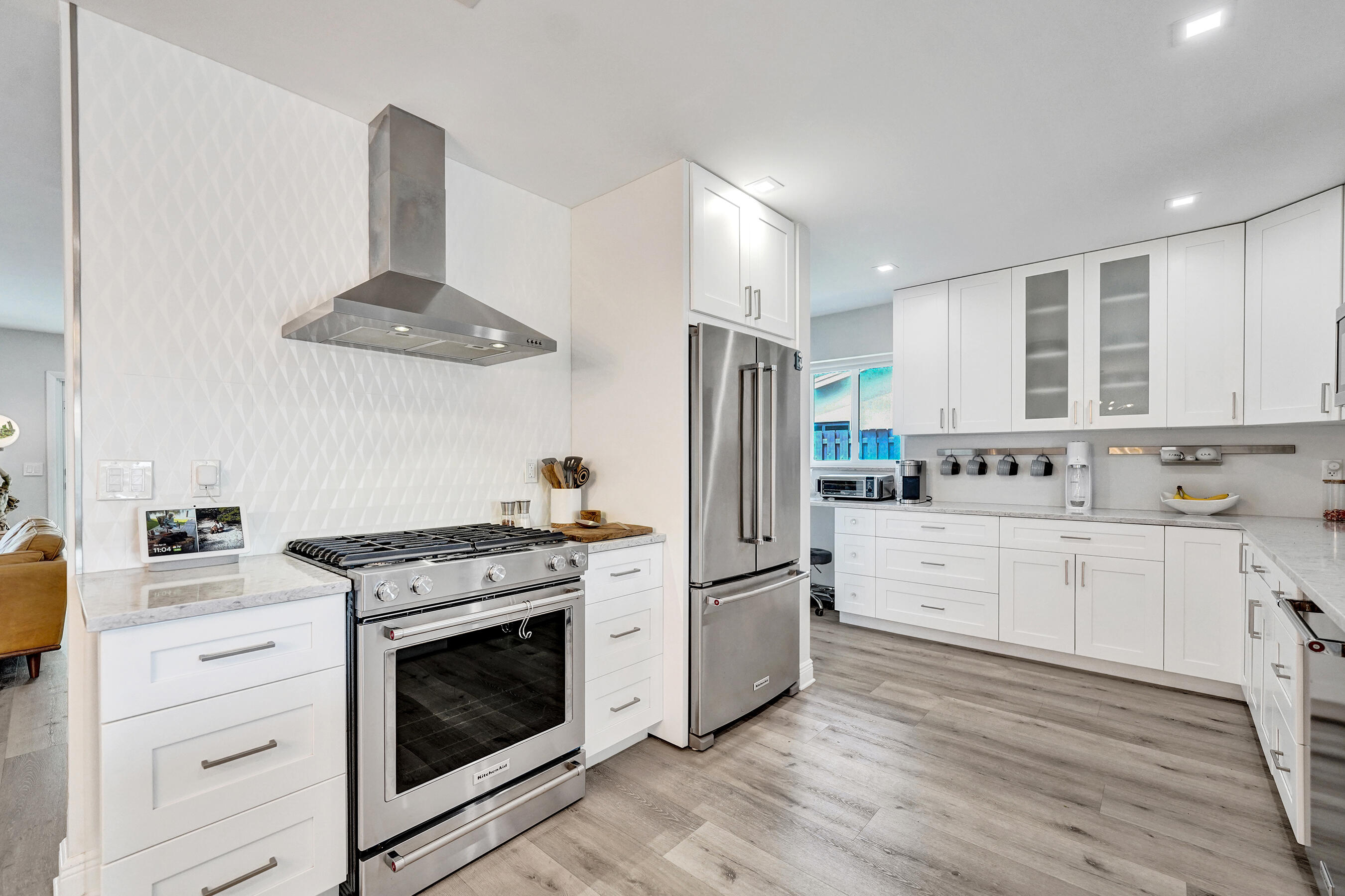 381 Southeast 3rd Street Pompano Beach, FL 33060 - Photo 29 of 41 a kitchen with stainless steel appliances a stove a sink and white cabinets