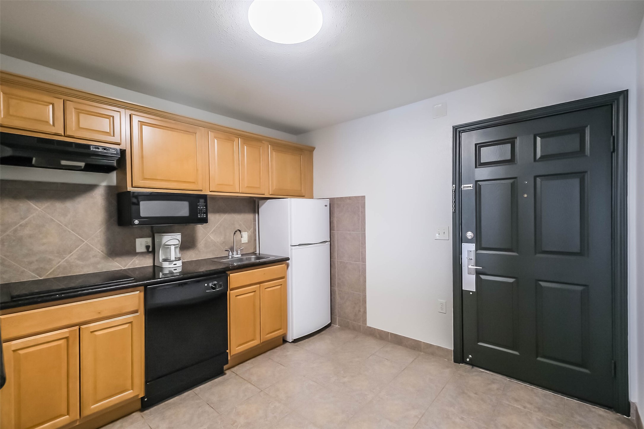 1025 Swanson Street, Unit 209 Houston, TX 77030 - Photo 11 of 19 a kitchen with stainless steel appliances granite countertop white cabinets sink and a granite counter top