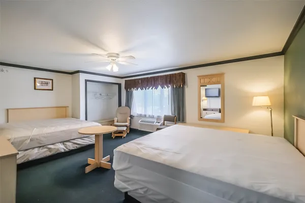 a bedroom with a bed and window