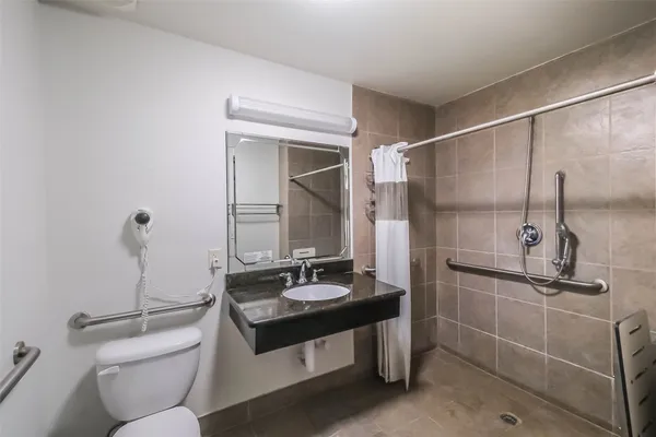 a bathroom with a sink toilet and shower