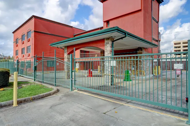 a view of a house with a small yard and wooden fence