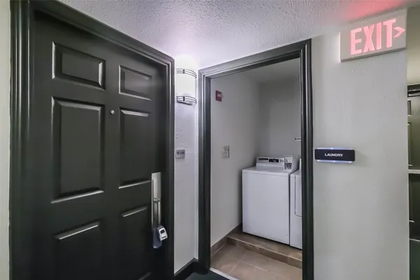 a view of a hallway with closet and wooden door