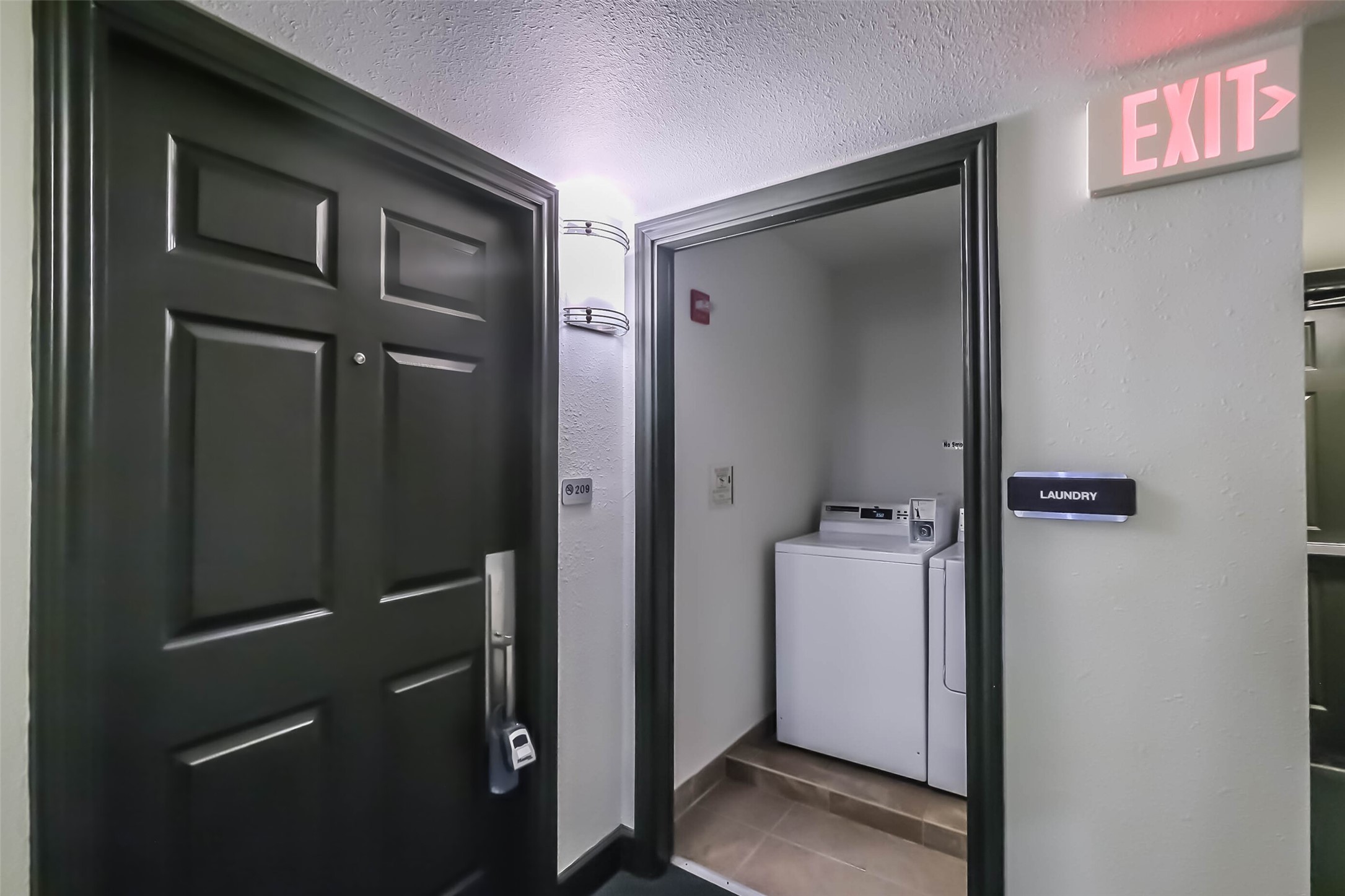 1025 Swanson Street, Unit 209 Houston, TX 77030 - Photo 9 of 19 a view of a hallway with closet and wooden door