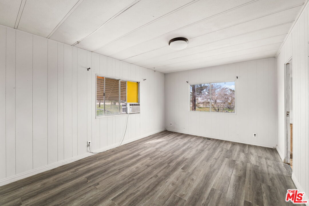 4388 Amador Road Phelan, CA 92371 - Photo 17 of 56 a view of an empty room with wooden floor and a window