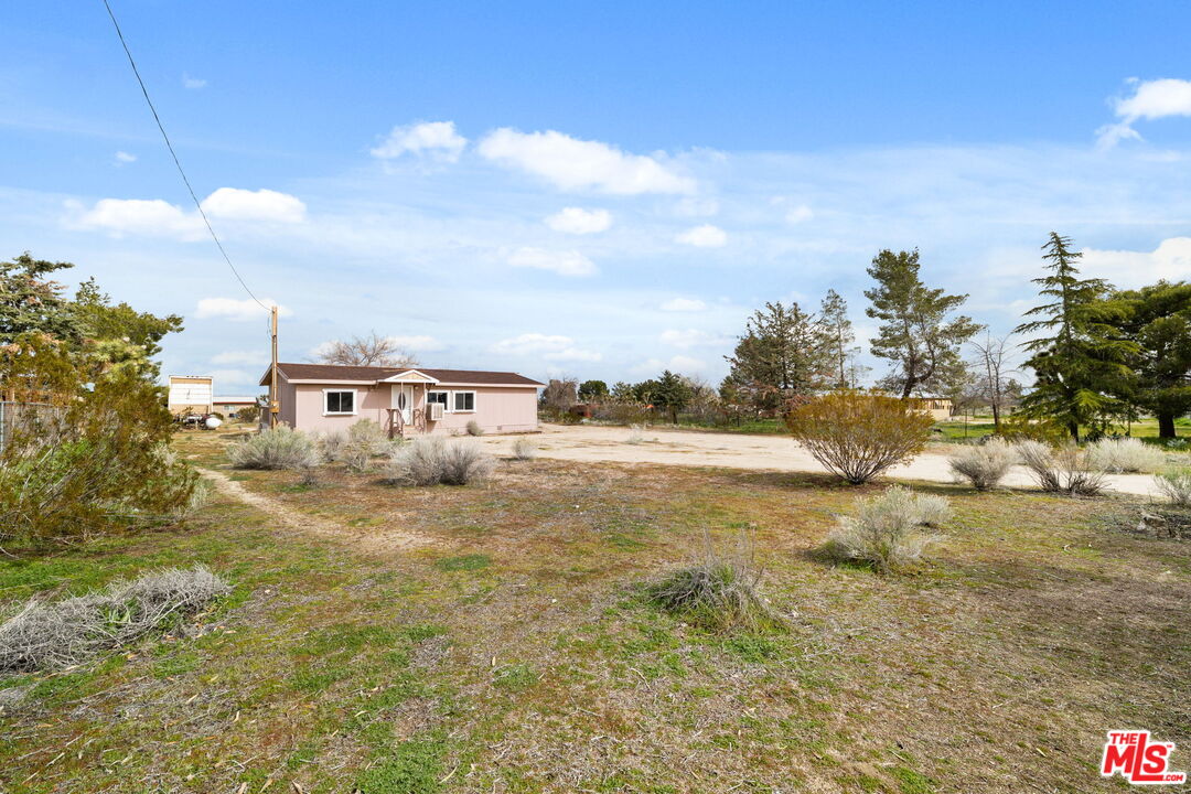 4388 Amador Road Phelan, CA 92371 - Photo 26 of 56 a view of a large house with a yard