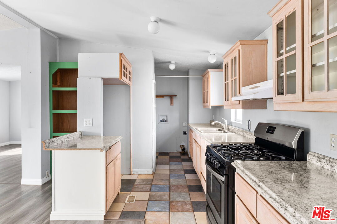 4388 Amador Road Phelan, CA 92371 - Photo 27 of 53 a kitchen with stainless steel appliances granite countertop a stove and a sink