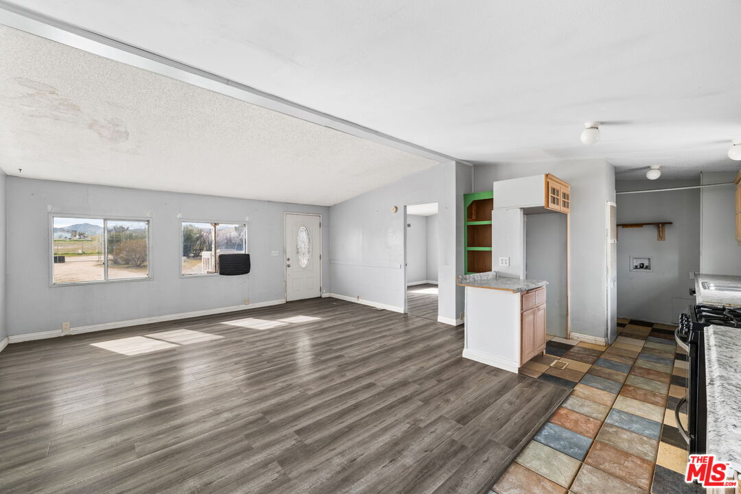 4388 Amador Road Phelan, CA 92371 - Photo 30 of 56 a view of a big room with wooden floor and windows