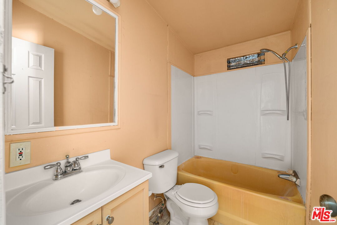 4388 Amador Road Phelan, CA 92371 - Photo 32 of 53 a bathroom with a sink a toilet and a bathtub