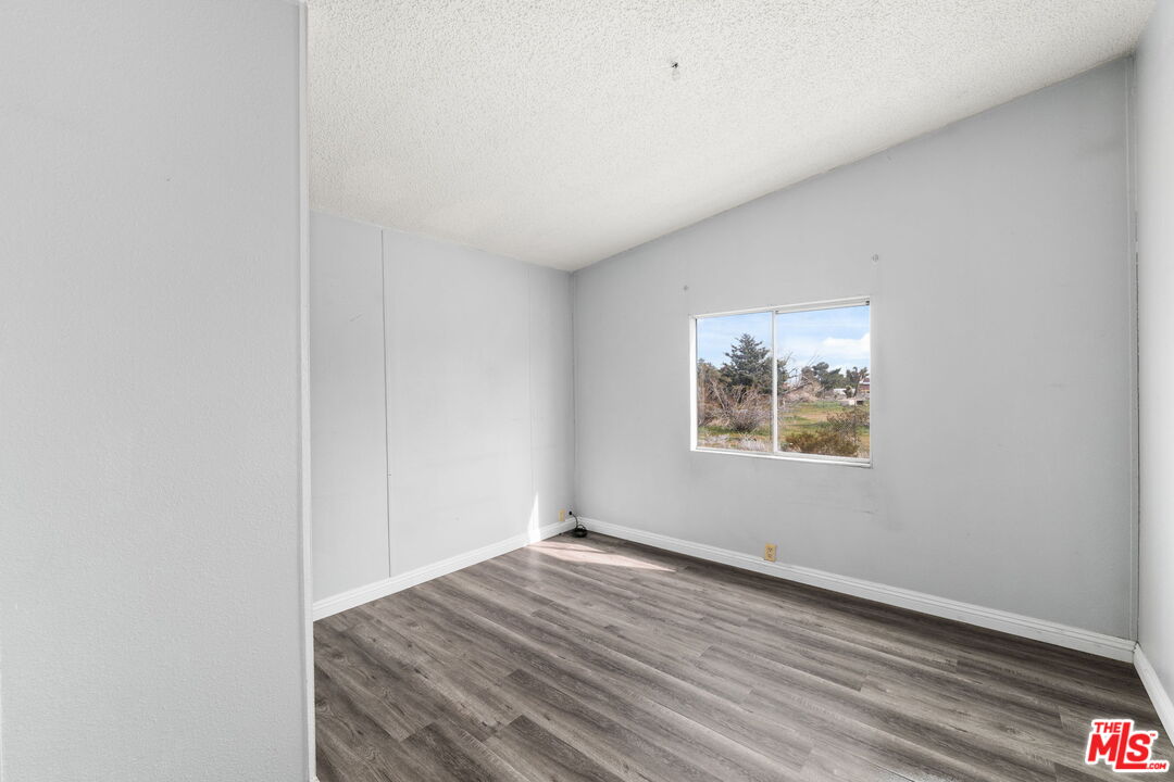 4388 Amador Road Phelan, CA 92371 - Photo 32 of 56 a view of empty room with wooden floor