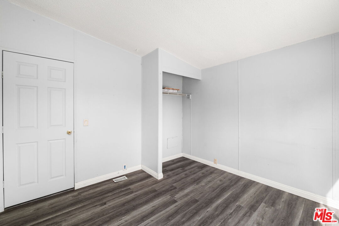 4388 Amador Road Phelan, CA 92371 - Photo 33 of 56 a view of an empty room with wooden floor