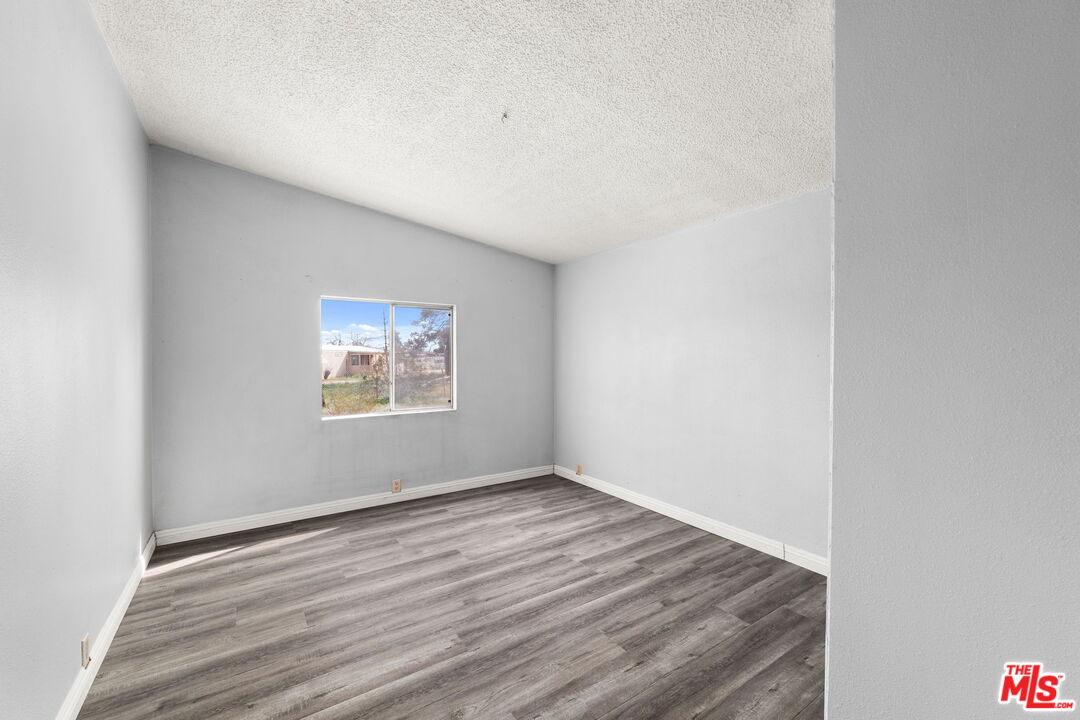 4388 Amador Road Phelan, CA 92371 - Photo 33 of 53 a view of an empty room with wooden floor