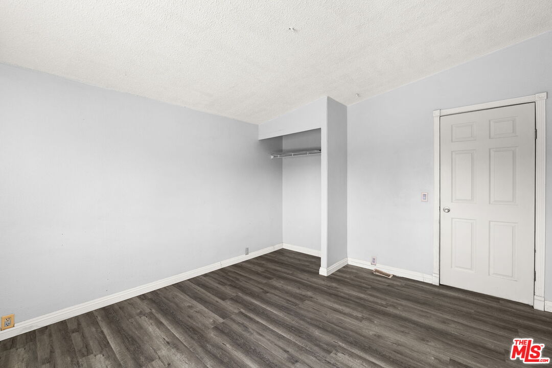 4388 Amador Road Phelan, CA 92371 - Photo 34 of 53 a view of an empty room with wooden floor and closet