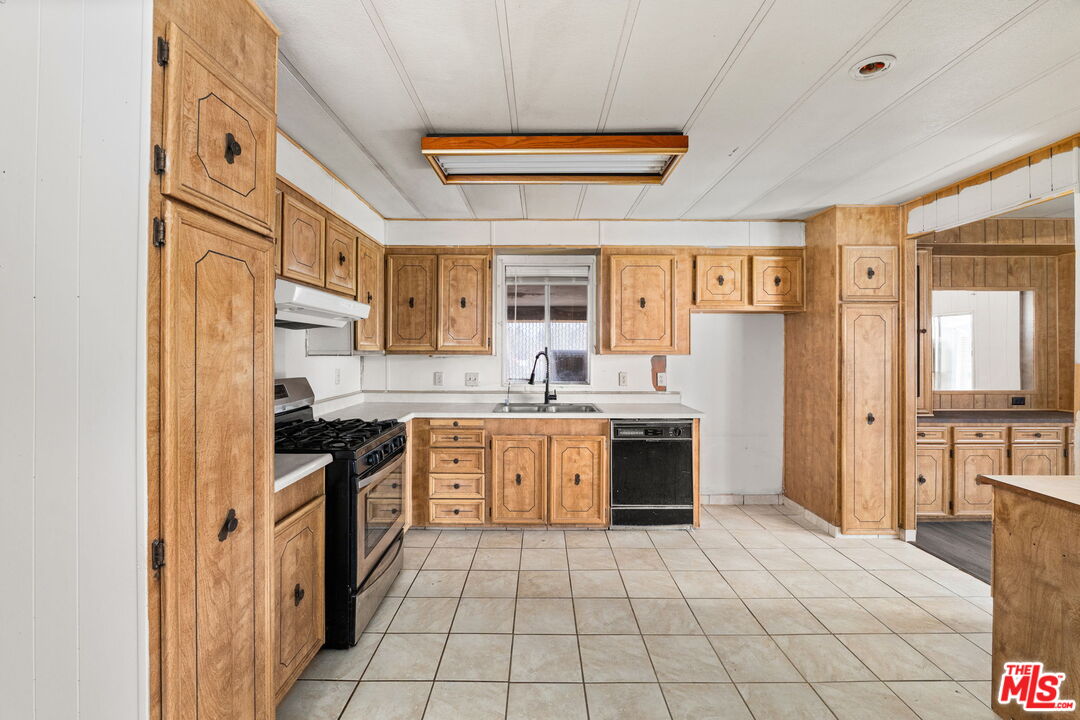 4388 Amador Road Phelan, CA 92371 - Photo 8 of 56 a large kitchen with stainless steel appliances granite countertop a stove and a sink