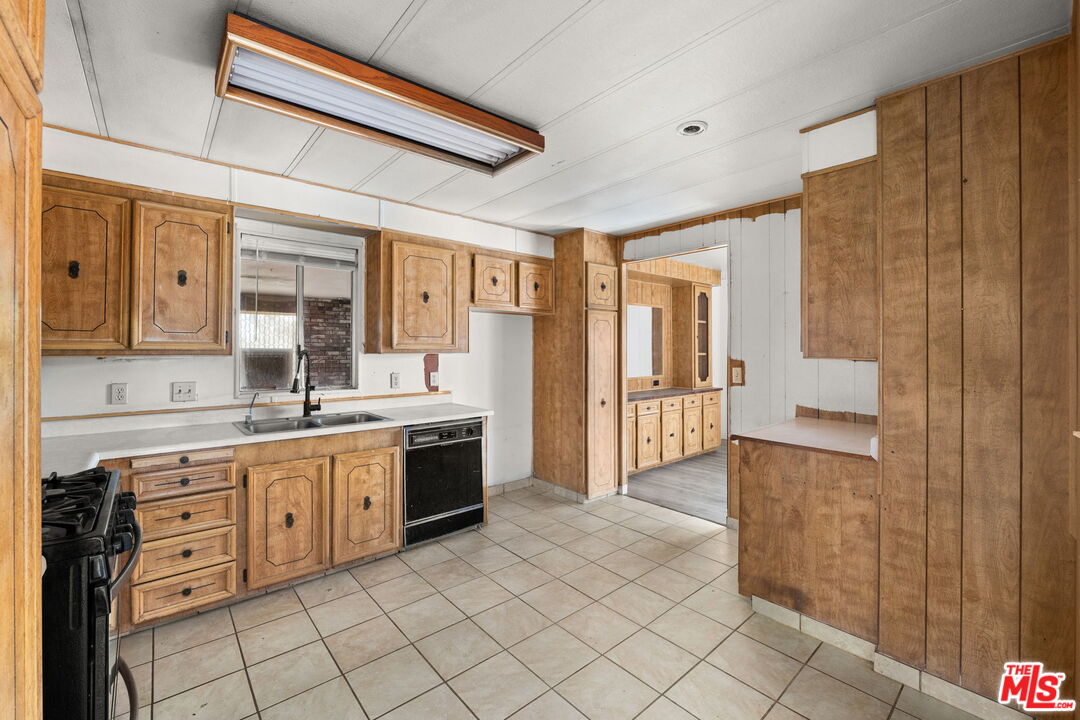4388 Amador Road Phelan, CA 92371 - Photo 9 of 56 a large kitchen with a sink and cabinets