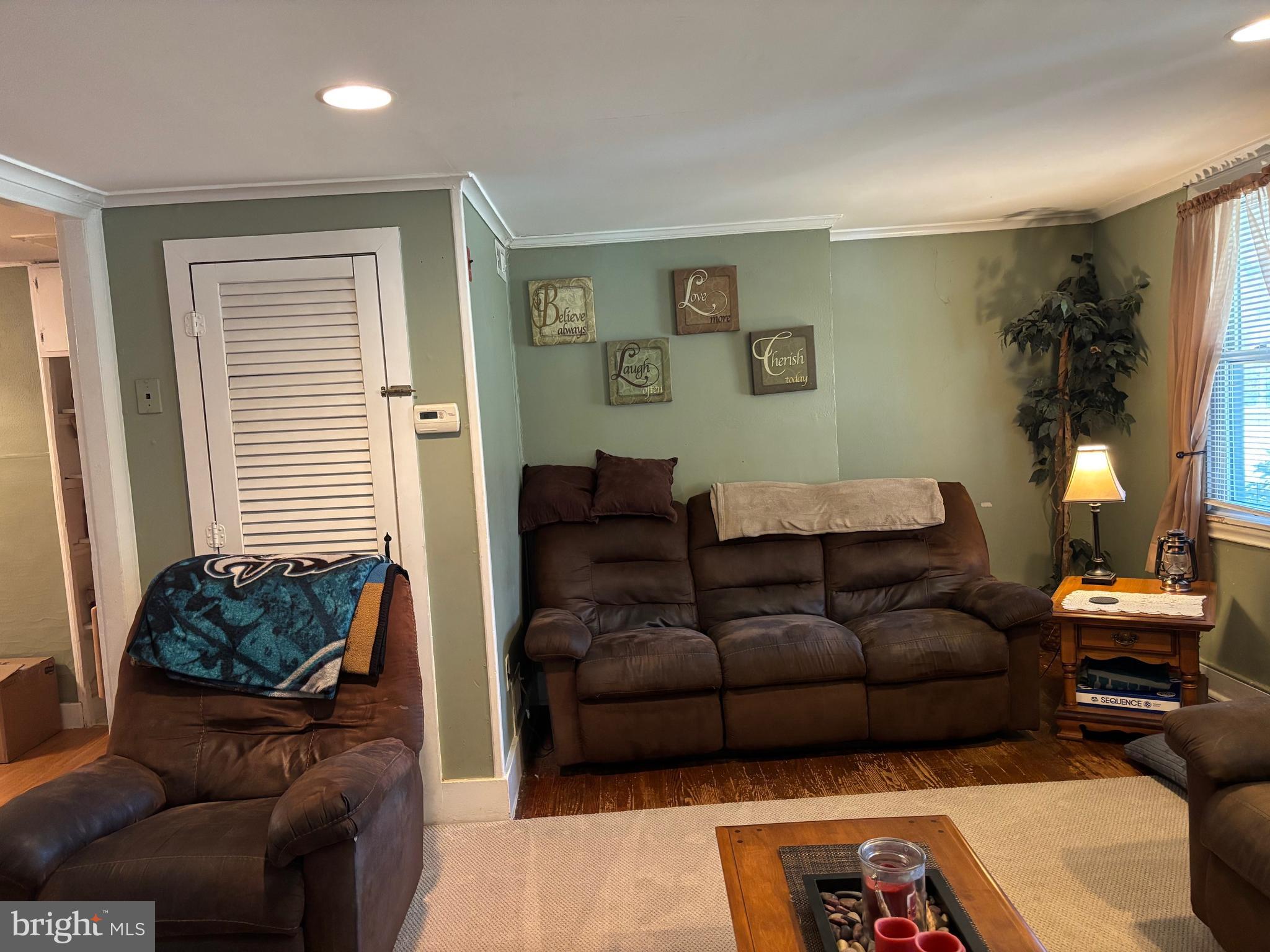 70 Main Street Waretown, NJ 08758 - Photo 16 of 54 a living room with furniture and a potted plant