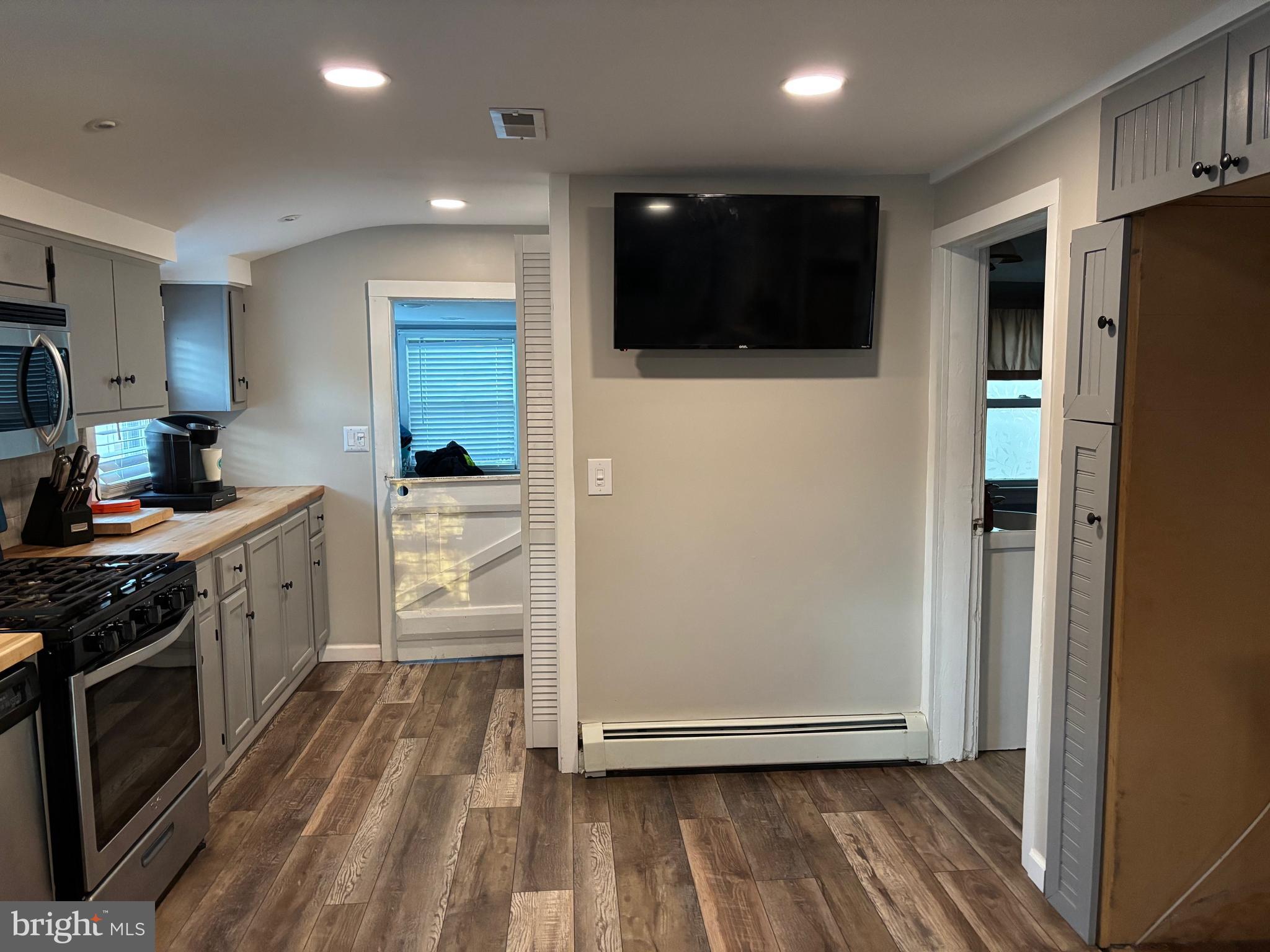 70 Main Street Waretown, NJ 08758 - Photo 20 of 54 a kitchen with stainless steel appliances a refrigerator a sink a stove a microwave and cabinets