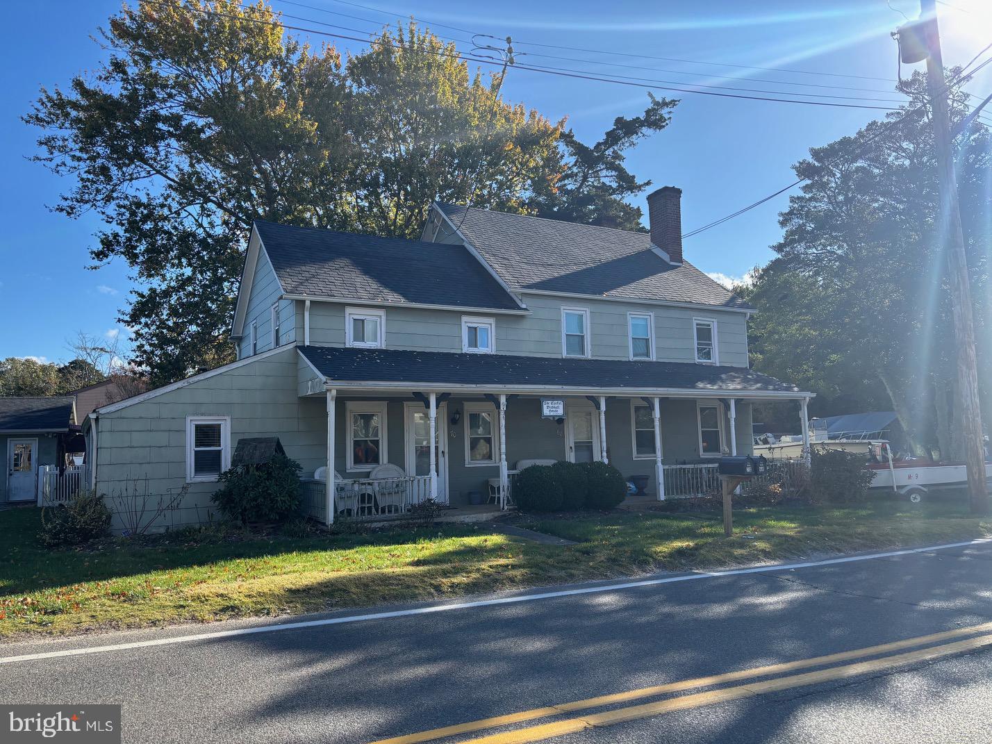 70 Main Street Waretown, NJ 08758 - Photo 3 of 54 a front view of a house with a garden
