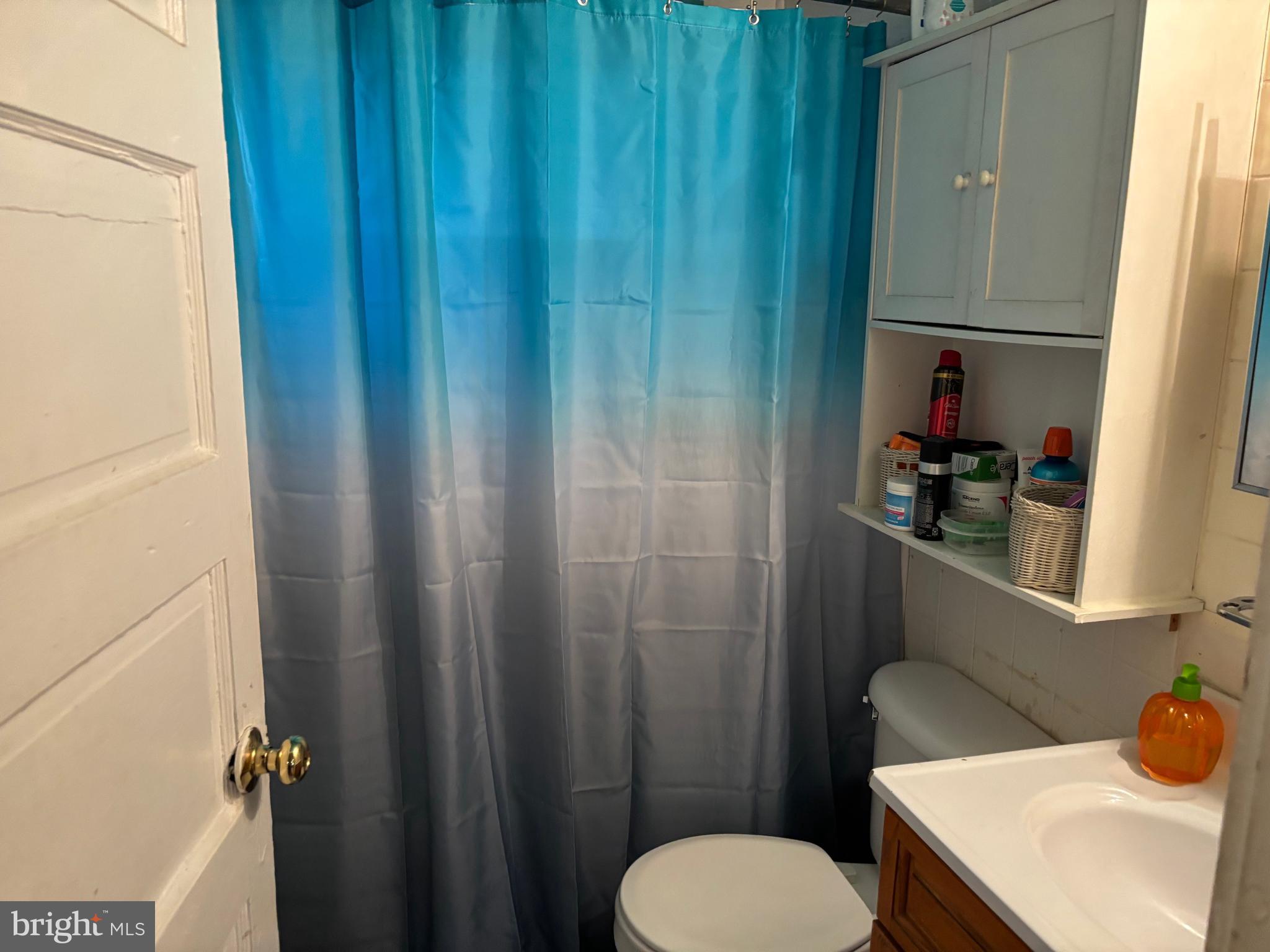 70 Main Street Waretown, NJ 08758 - Photo 45 of 54 a bathroom with a sink toilet and shower curtain