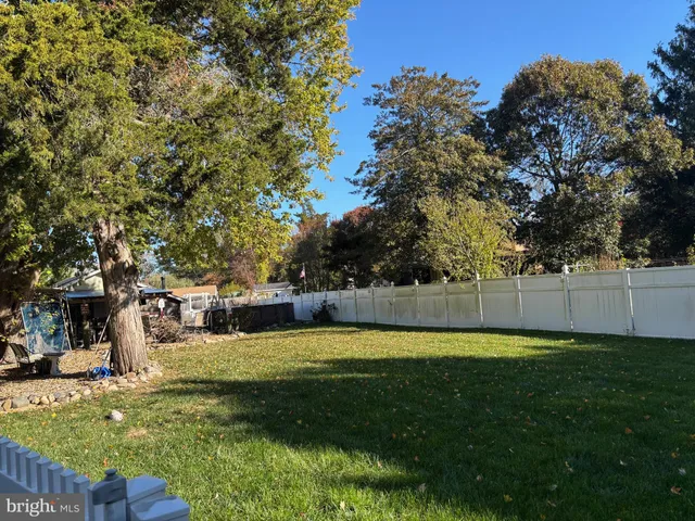 a kitchen with stainless steel appliances granite countertop a stove a sink dishwasher and a microwave oven with wooden floor